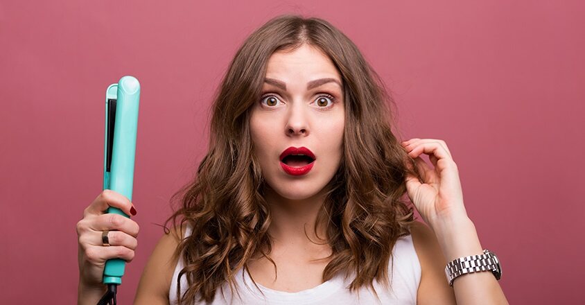 woman holding straightener with distressed look