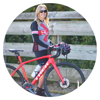Genesis patient posing for photo by her bicycle outside