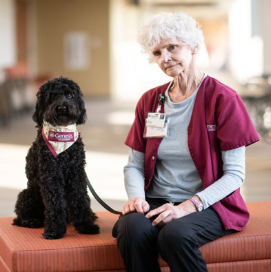 Genesis therapy dog, Oliver, Labradoodle breed, with owner Lois Gruenebaum