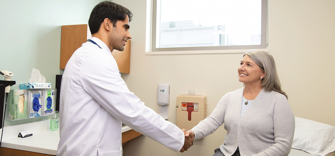 Avneek Sandhu, M.D. photographed with a patient