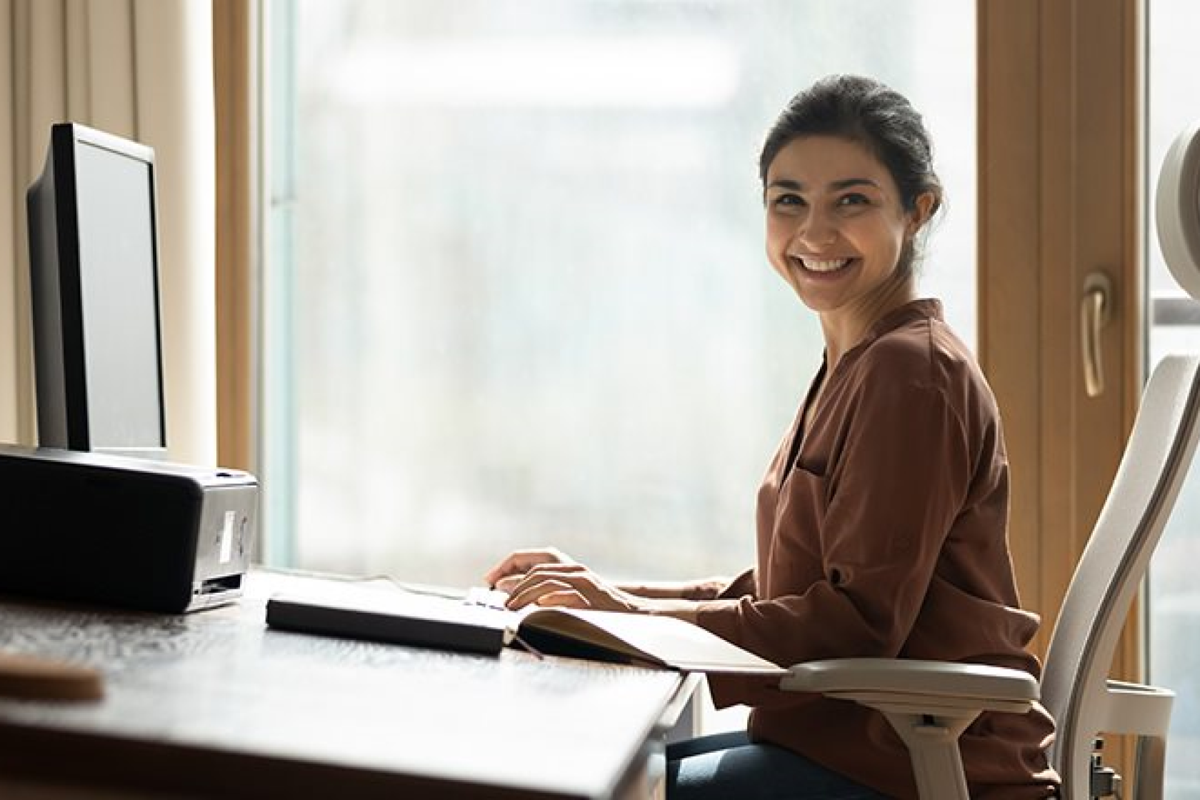 woman sitting straight at desk