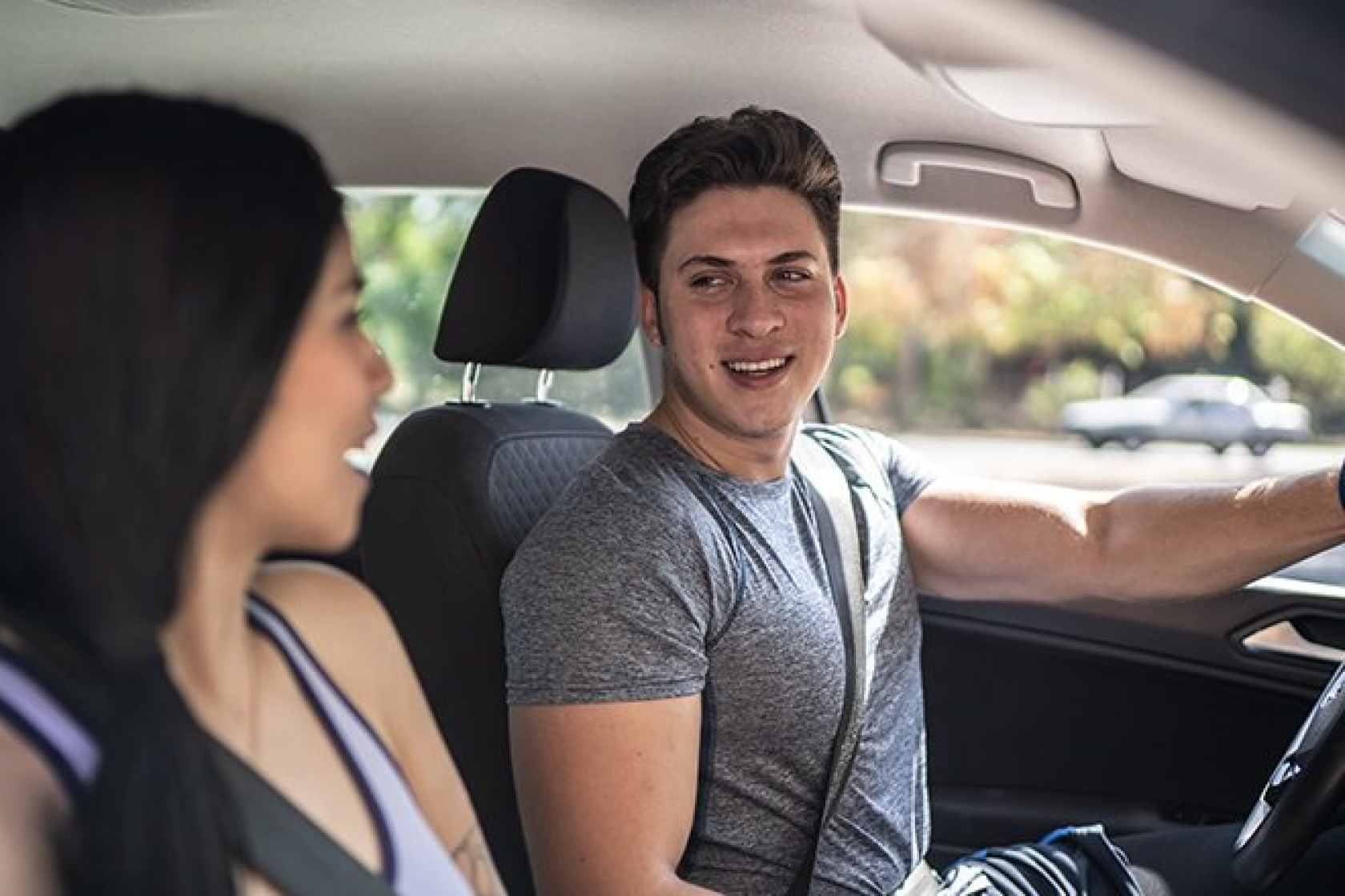 a person sitting straight behind the wheel of a car