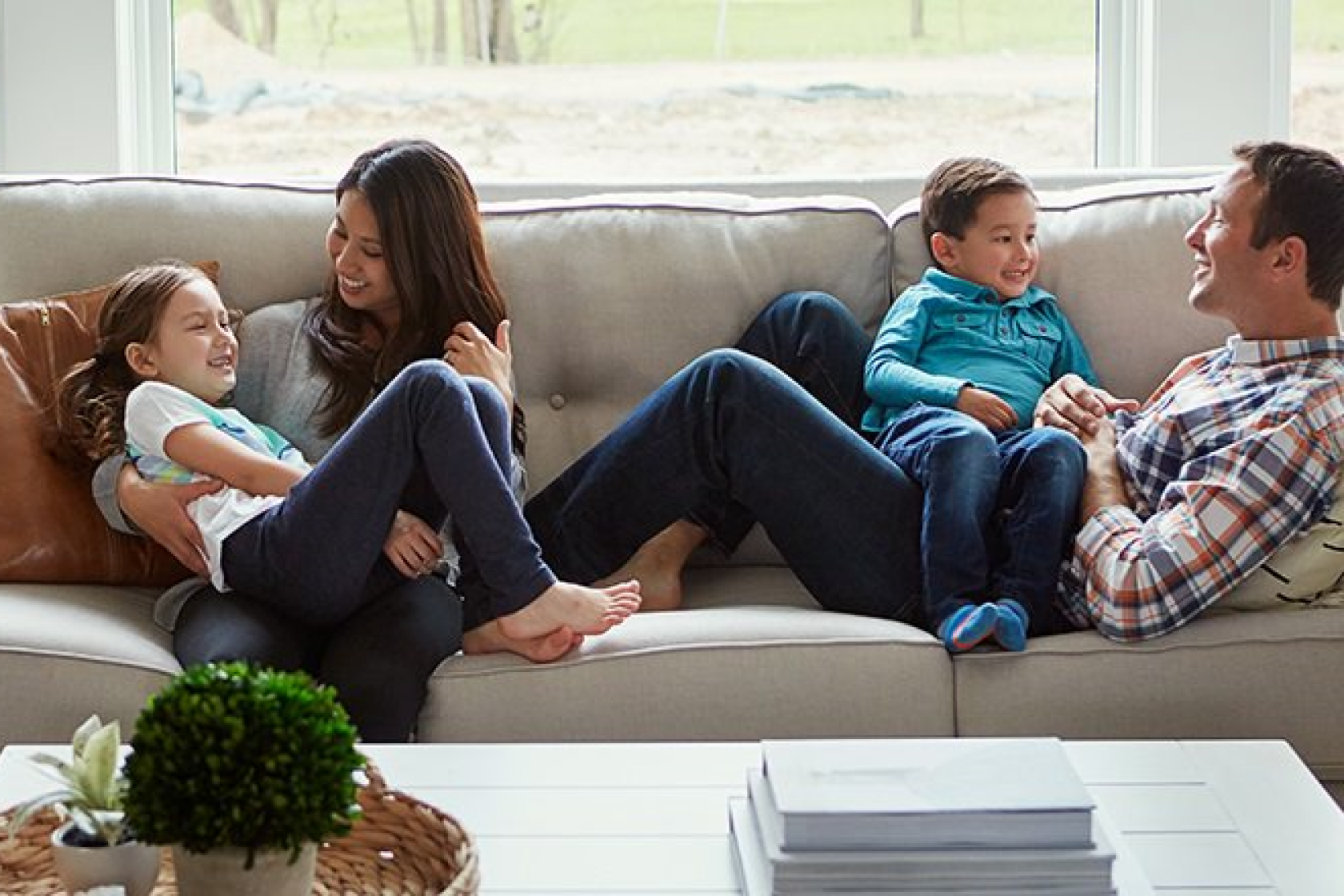 family relaxing on couch smiling