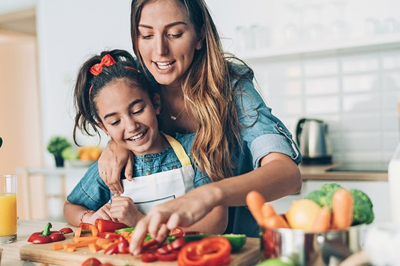 mother and daughter preparing vegetables together