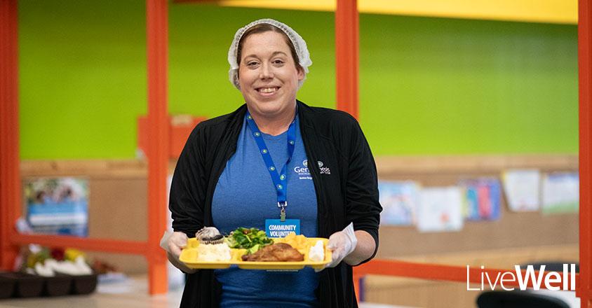 Genesis employee volunteering at Christ's Table