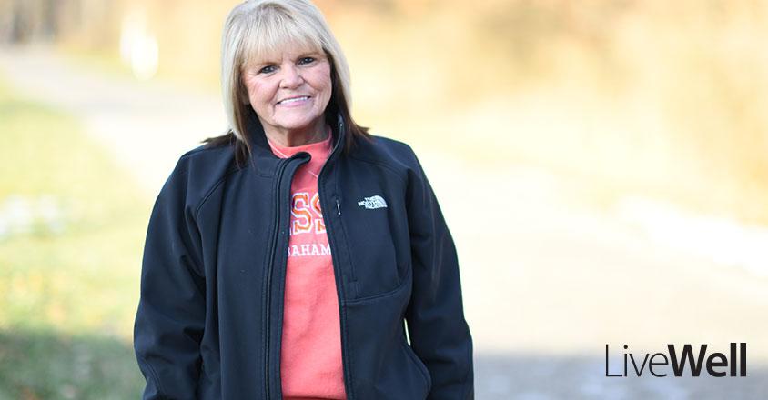 Genesis Heart and Vascular patient testimony feature image of Julie McClure, smiling outside on a sunny winter day