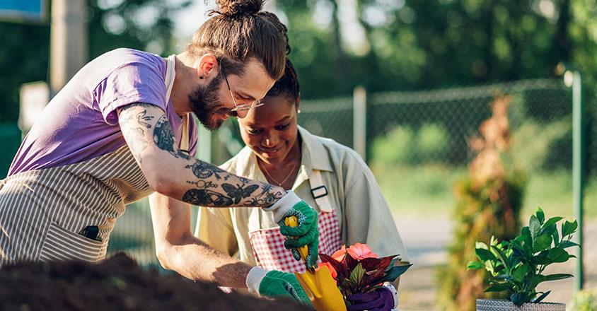 man and woman gardening together, happy