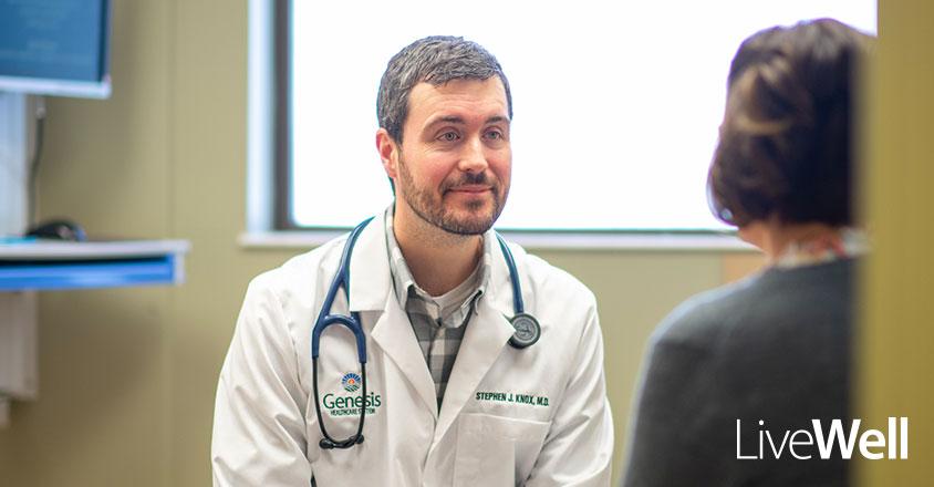 Stephen Knox, M.D. Primary Care Physician at Genesis Primary Care siting with a patient 