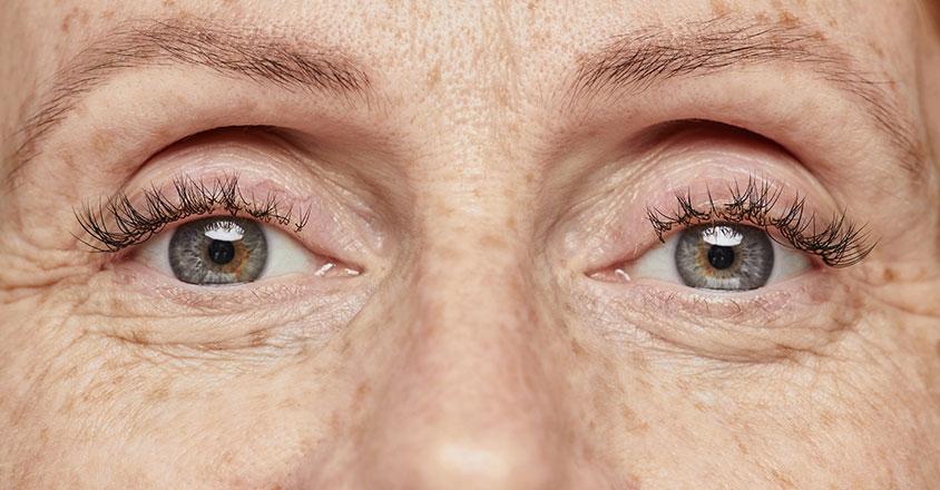 grown woman's blue eyes zoomed in, emphasizing beautiful skin and wrinkles