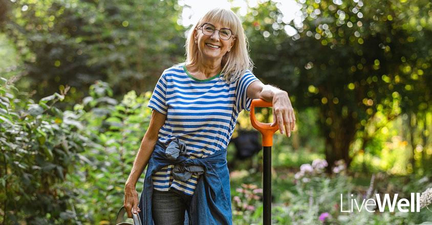 woman smiling while gardening outside 