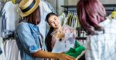 woman shopping at clothing store with friends