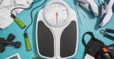 photo of scale with exercise equipment surrounding (i.e., jump rope, sneakers, dumbell weights)