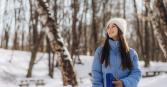 woman standing outside in the winter bundled up and smiling