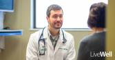 Stephen Knox, M.D. Primary Care Physician at Genesis Primary Care siting with a patient 