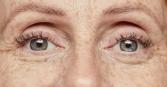 grown woman's blue eyes zoomed in, emphasizing beautiful skin and wrinkles