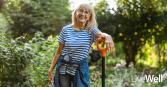 woman smiling while gardening outside 