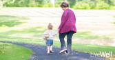 Natalie Thompson, Genesis Cancer Care Center patient enjoys life after cancer with her daughter as they are photographed walking through a sunny park