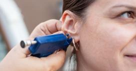 Woman getting her ear professionally pierced for jewelry