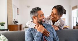 woman embracing man, both smiling at each other