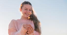younger woman smiling with a sparkler in her hand
