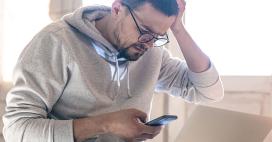 man stressed looking at his phone