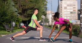 man and woman stretching outside