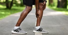 close up of man holding his calf muscle, representing a muscle cramp