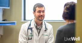 Stephen Knox, M.D. Primary Care Physician at Genesis Primary Care siting with a patient 