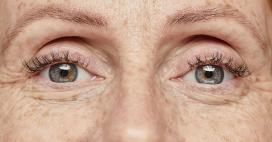 grown woman's blue eyes zoomed in, emphasizing beautiful skin and wrinkles